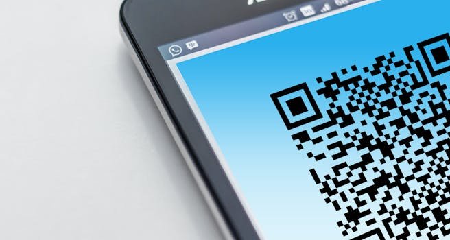 High-resolution close-up of a smartphone displaying a QR code on its screen. portaria