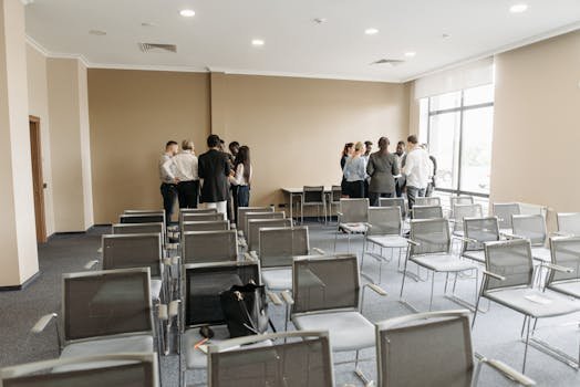 A diverse group of professionals having a discussion in an empty conference room. assembleia