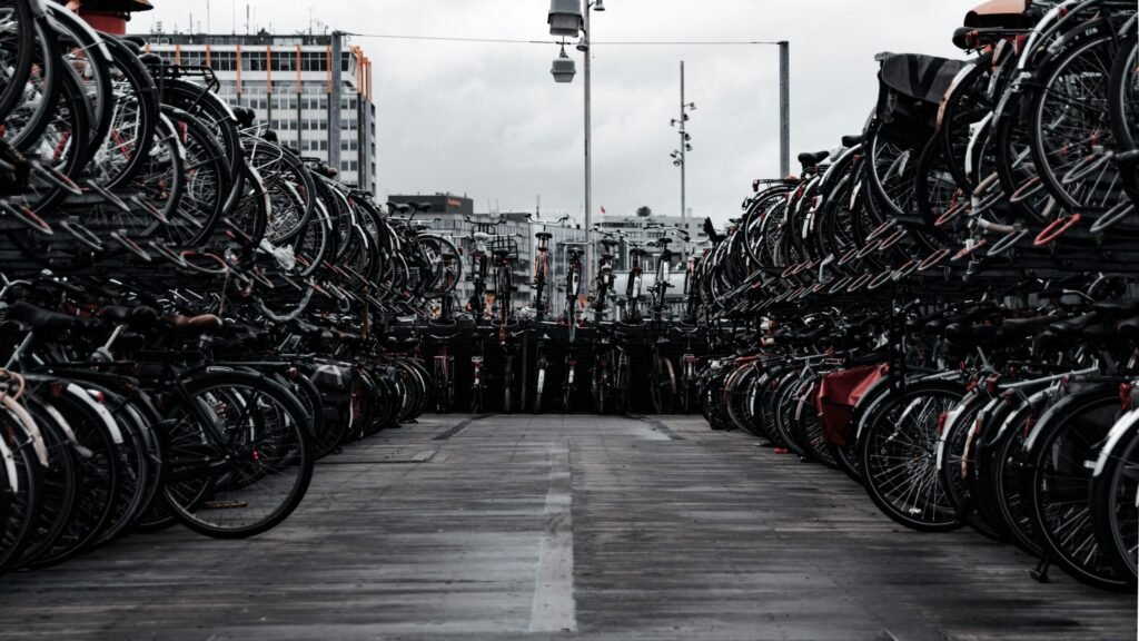 Crowded bicycle parking lot in Amsterdam showcasing urban transport culture.