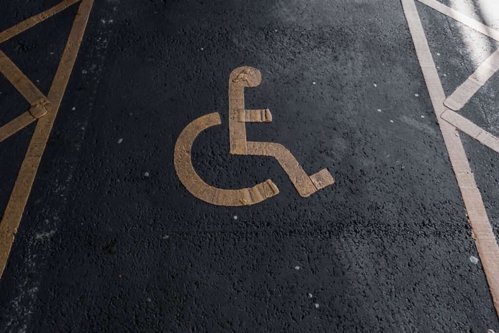 Close-up of a handicapped parking sign painted on pavement for accessibility clarity.